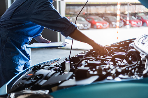 car mechanic working on engine